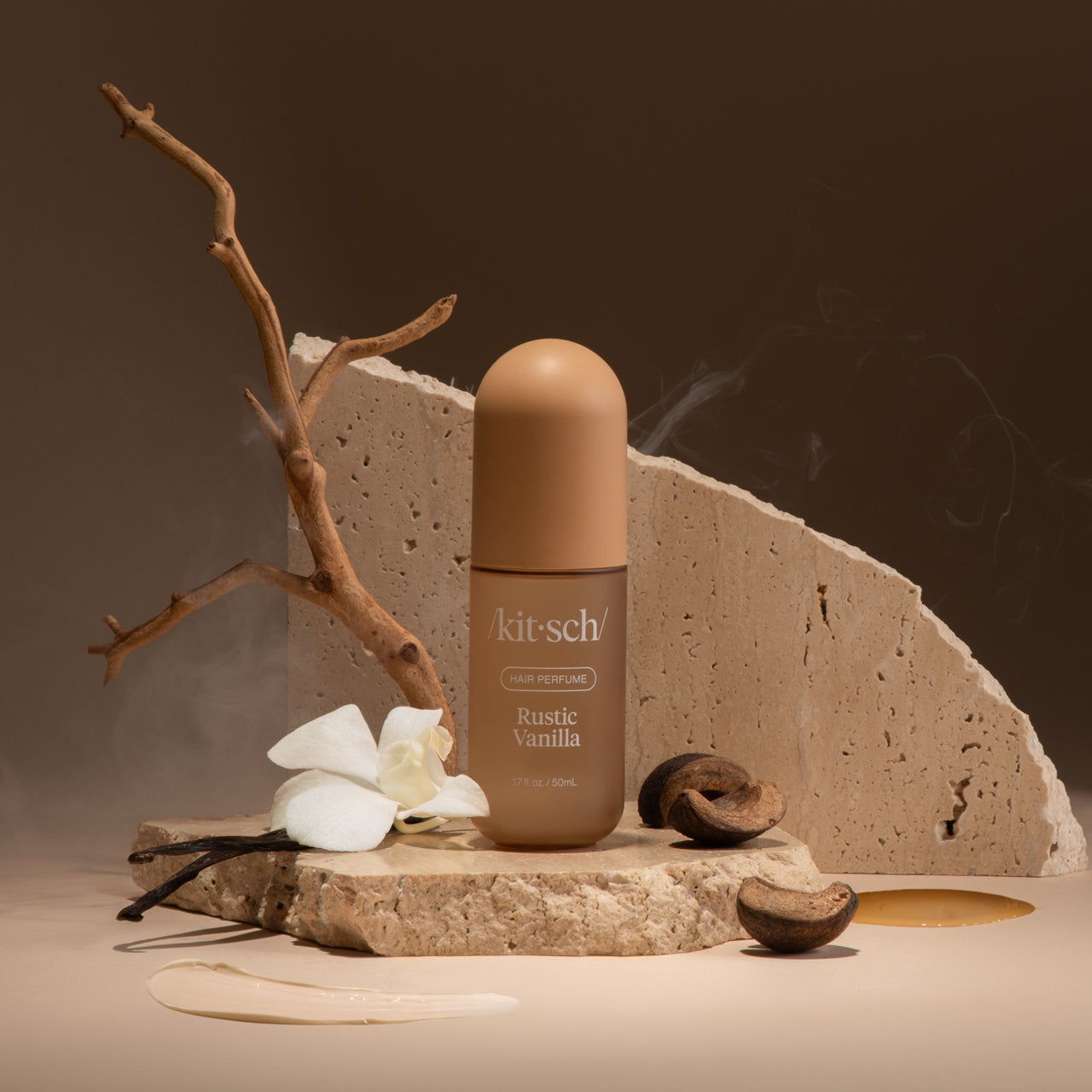 Model misting Kitsch Rustic Vanilla Hair Perfume onto smooth, wavy hair