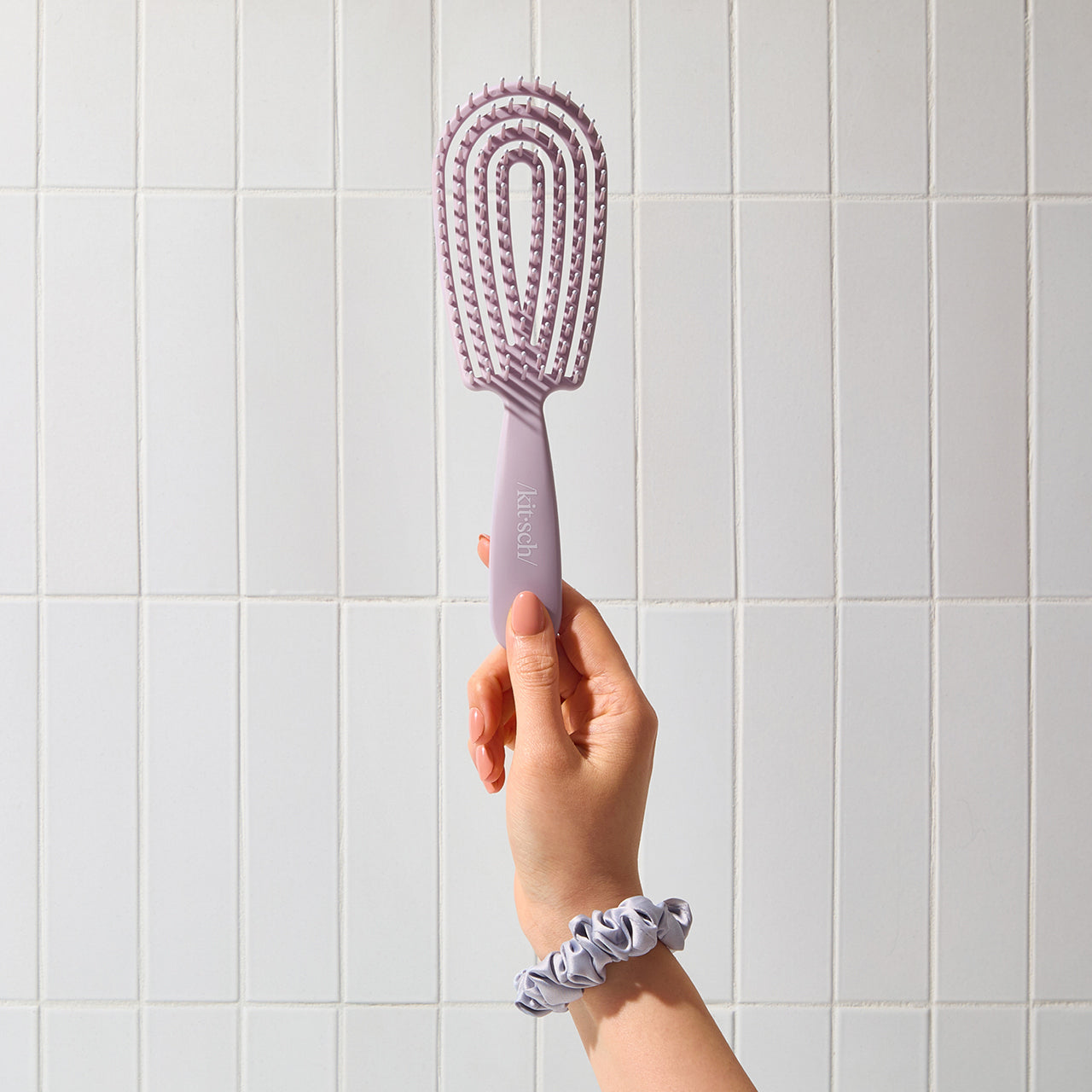 Kitsch Soft Violet Detangling Flexi Brush angled view showing ergonomic handle and brush head