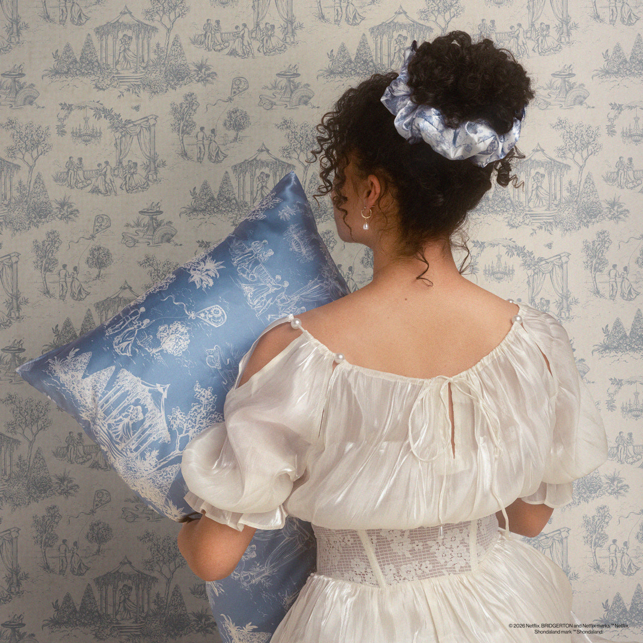 KITSCH Bridgerton x Kitsch Satin Pillow Scrunchies® in Toile in Bloom — model wearing Bridgerton satin pillow scrunchie — vibrant floral Toile print, silky satin gentle on all hair types