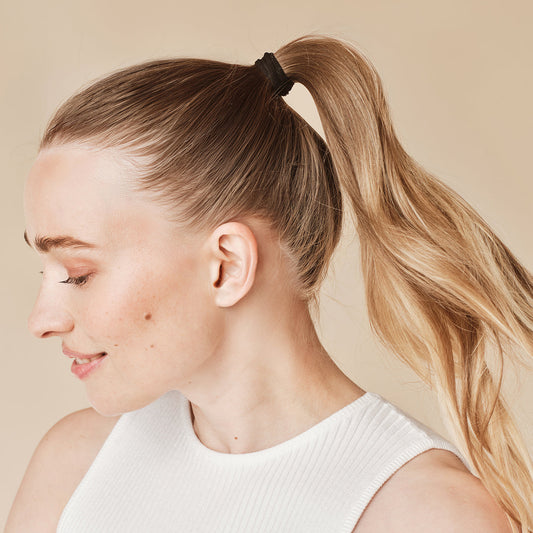 KITSCH Black Elastic Hair Ties 20pc Set — model wearing black hair elastic — Glide gently through hair for a tight all-day hold — consciously created from recycled materials, eco-friendly too
