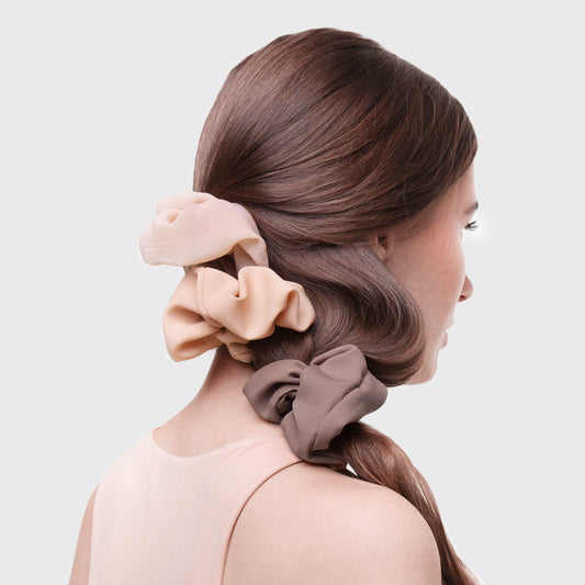 KITSCH Crepe Scrunchies in Terracotta — lifestyle shot of terracotta crepe scrunchies in hair — warm terra cotta tones with textured crepe fabric