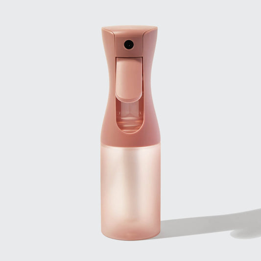 Model using Terracotta Continuous Spray to mist hair showing fine mist output