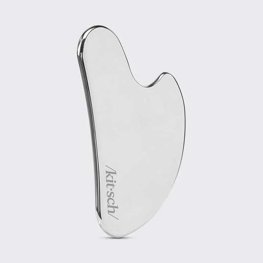 Model using Stainless Steel Gua Sha along jawline showing 15-degree angle technique