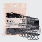 KITSCH Black No-Snag Elastics 100pc Set — hero product shot — black hair elastics fanned out beside the kraft pouch packaging — easy-glide coating removes without snagging