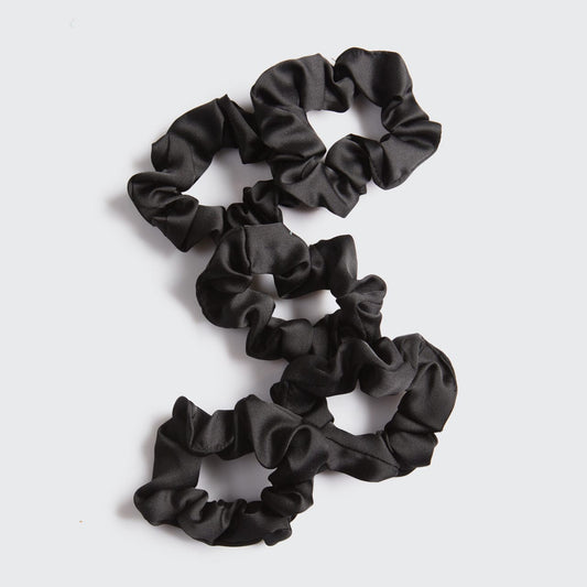 KITSCH Black Satin Sleep Scrunchies 5pc Set — lifestyle product shot showing black satin scrunchie — silky satin construction won't crimp hair while you sleep