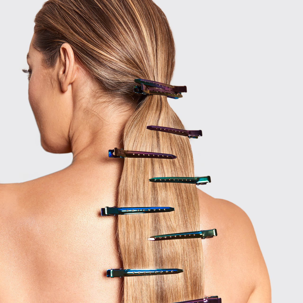 KITSCH Iridescent Styling Hair Clips 6pc Set — model shot — model sectioning hair with iridescent clips during a blowout