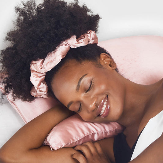 Model sleeping on KITSCH Blush King Satin Pillowcase