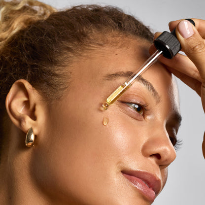 KITSCH Dermaplane Oil — lifestyle application shot — model applying oil to face before dermaplaning — for a smoother makeup base
