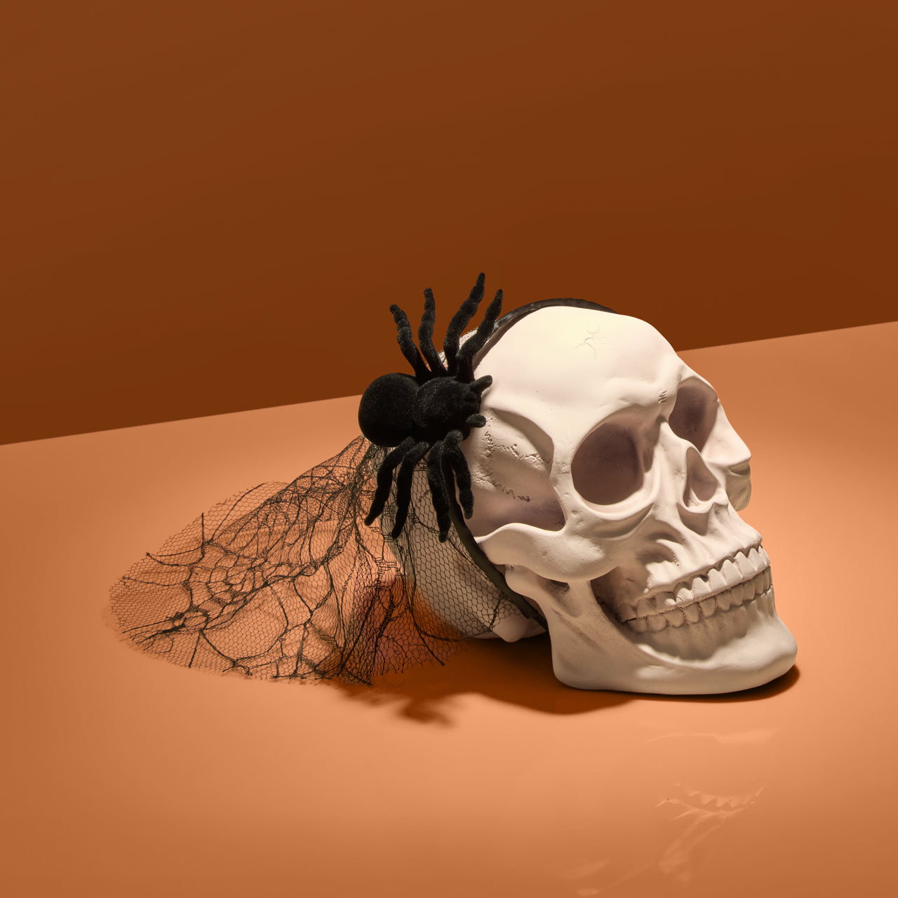 KITSCH Spiderweb Veil Headband — creative flat lay of spiderweb veil headband — statement Halloween hair accessory