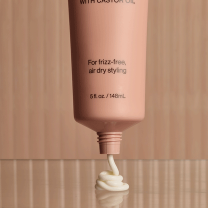 KITSCH Smoothing Air Dry Cream — animated product shot showing bottle from multiple angles — Infused with Castor Oil, Squalane, Panthenol & Coconut Oil to nourish, hydrate, and protect — sheer, non-greasy formula won't weigh hair down