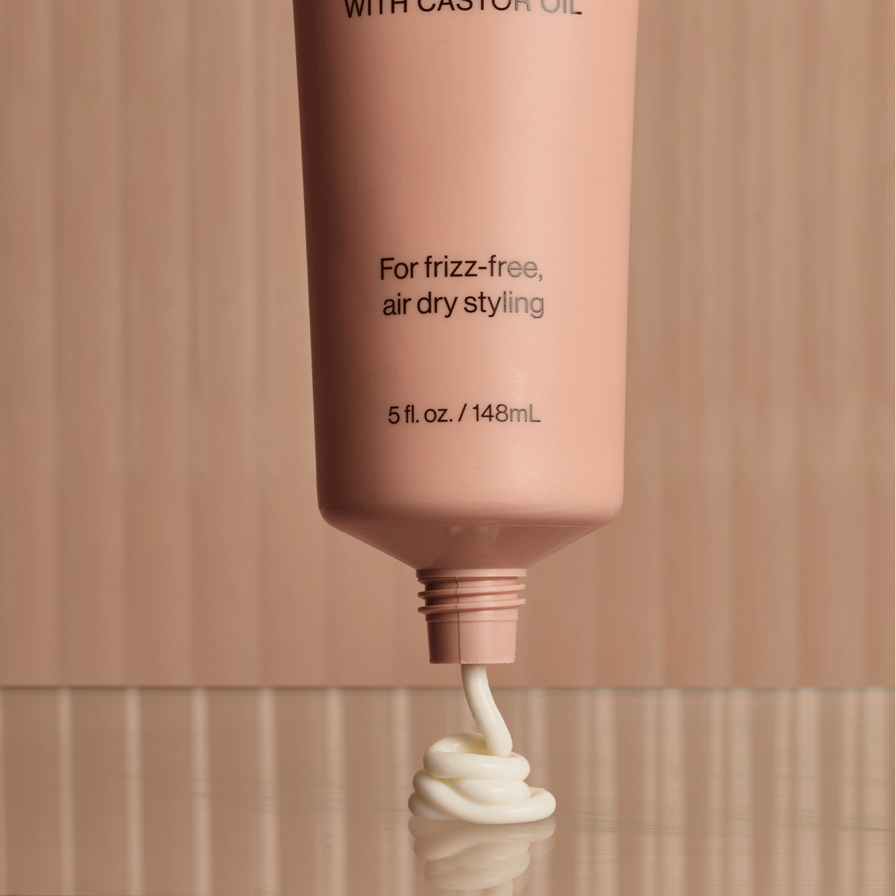 KITSCH Smoothing Air Dry Cream — animated product shot showing bottle from multiple angles — Infused with Castor Oil, Squalane, Panthenol & Coconut Oil to nourish, hydrate, and protect — sheer, non-greasy formula won't weigh hair down