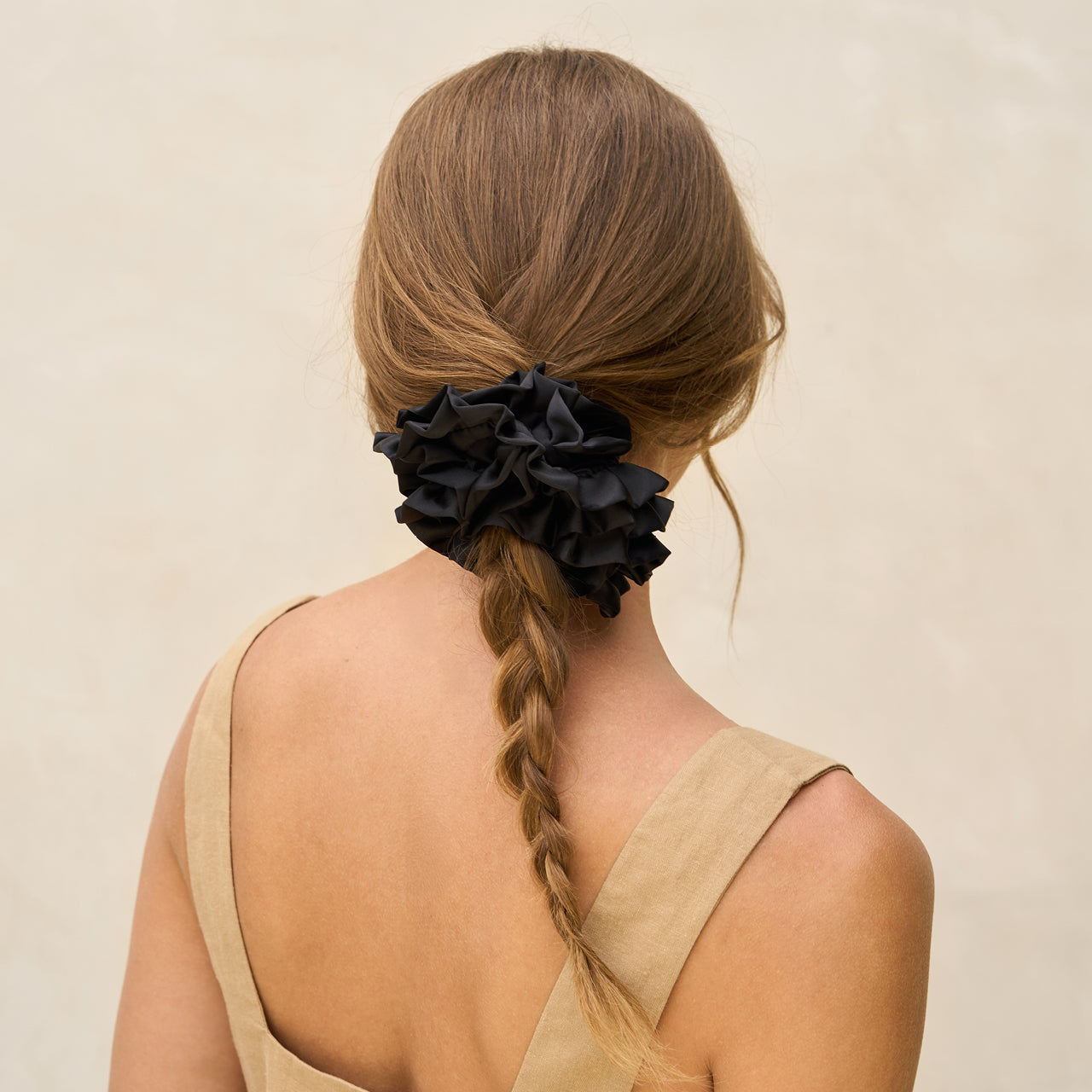 KITSCH Black Ruffle Scrunchie — model with black ruffle scrunchie in hair — eco-friendly recycled fabric with a voluminous ruffle for effortless style