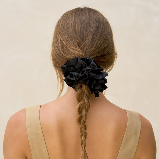 KITSCH Black Ruffle Scrunchie — model wearing black ruffle scrunchie — voluminous ruffle adds playful texture and style — made from soft recycled fabric