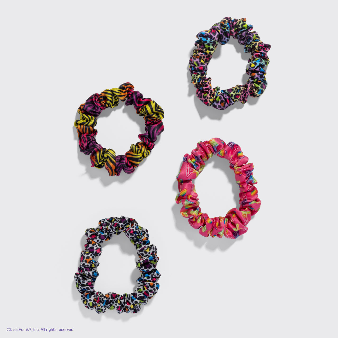 KITSCH Lisa Frank x Kitsch Ruched Satin Scrunchies in Rainbow Leopard — product flat lay showing rainbow leopard ruched satin scrunchies — vivid Lisa Frank x KITSCH collab colors