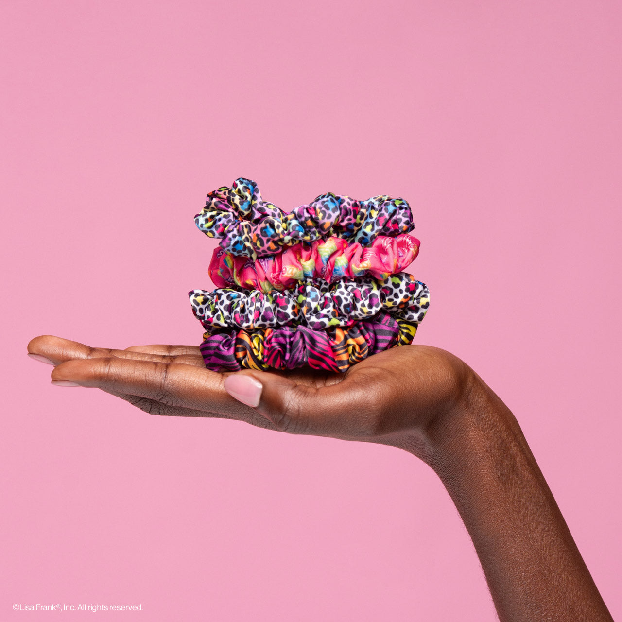 KITSCH Lisa Frank x Kitsch Ruched Satin Scrunchies in Rainbow Leopard — model wearing rainbow leopard ruched satin scrunchie — Lisa Frank x KITSCH collab, ruched design adds texture and volume