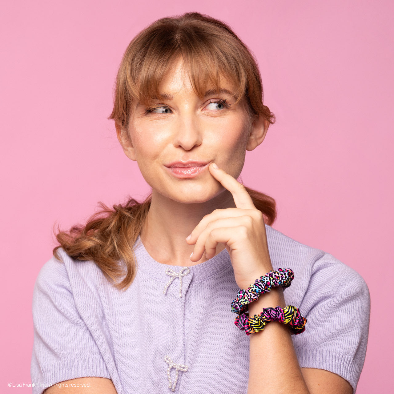 KITSCH Lisa Frank x Kitsch Ruched Satin Scrunchies in Rainbow Leopard — model styling hair with Lisa Frank rainbow scrunchie — ruched satin adds texture, gentle on all hair types