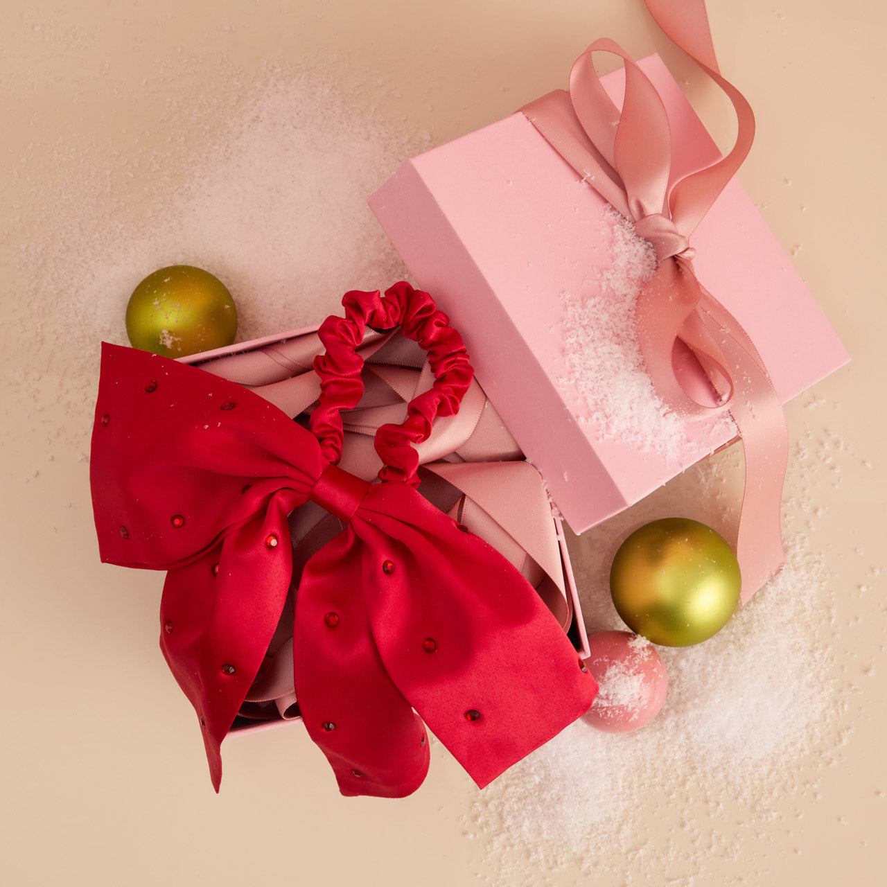 KITSCH Satin & Rhinestone Bow Scrunchie — close-up product detail of rhinestone bow — sparkling rhinestone embellishment on silky red satin — limited-edition seasonal design