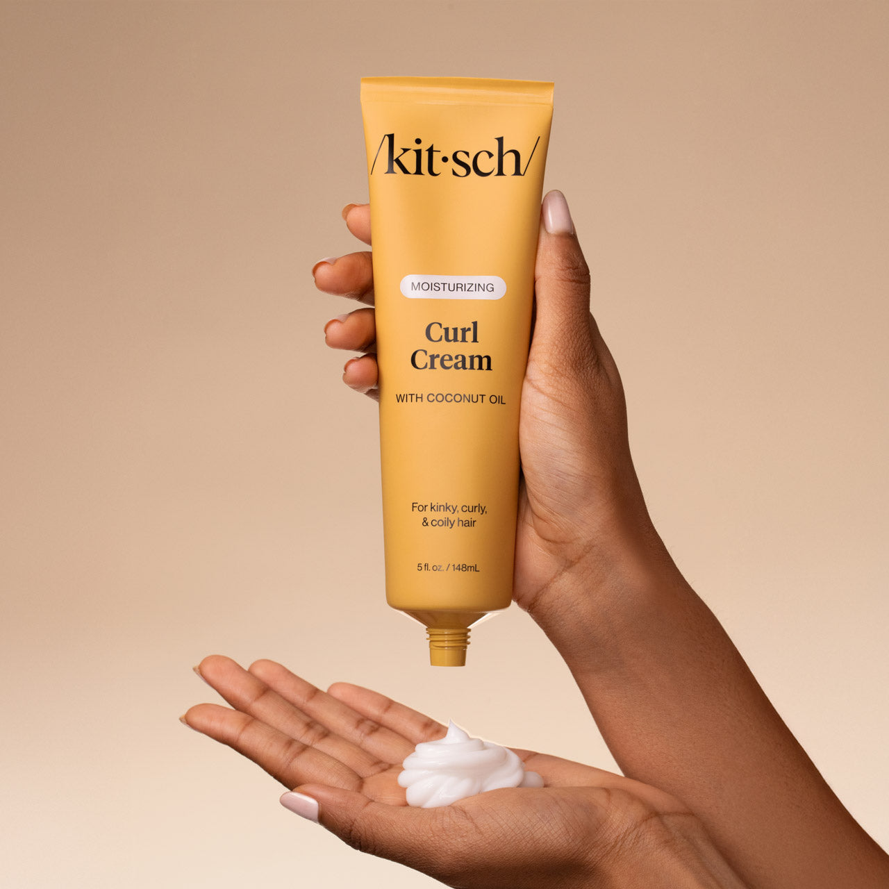 KITSCH Moisturizing Curl Cream — model applying cream to palm — Rich yet feather-light formula crafted to hydrate deeply, enhance curl memory, and awaken your hair's natural pattern — delivers a touchable hold that lasts