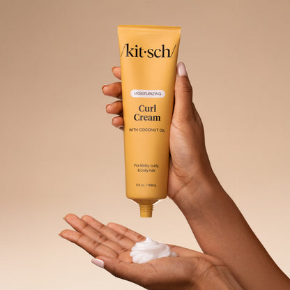 KITSCH Moisturizing Curl Cream — model applying cream to palm — Rich yet feather-light formula crafted to hydrate deeply, enhance curl memory, and awaken your hair's natural pattern — delivers a touchable hold that lasts