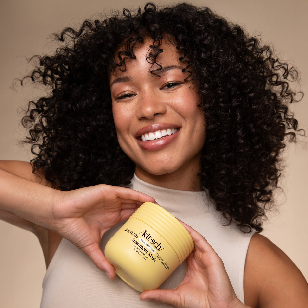 Model applying KITSCH Coconut Oil Deep Conditioning Treatment Mask – curly hair hydration
