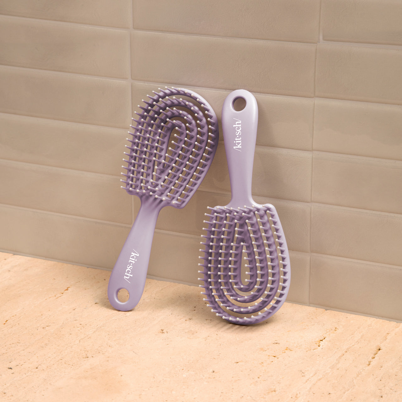 Kitsch Soft Violet Detangling Flexi Brush Mini side view showing flexible bristle base
