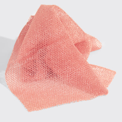Close-up view of the Berry Pink African Net Sponge textured mesh material highlighting its exfoliating design.