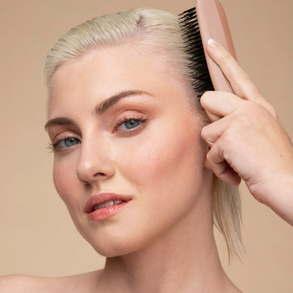 Model using the KITSCH Scalp Renewal Brush in Terracotta in the shower to massage shampoo into scalp — stimulates circulation and lather — part of the Bye Buildup Trio