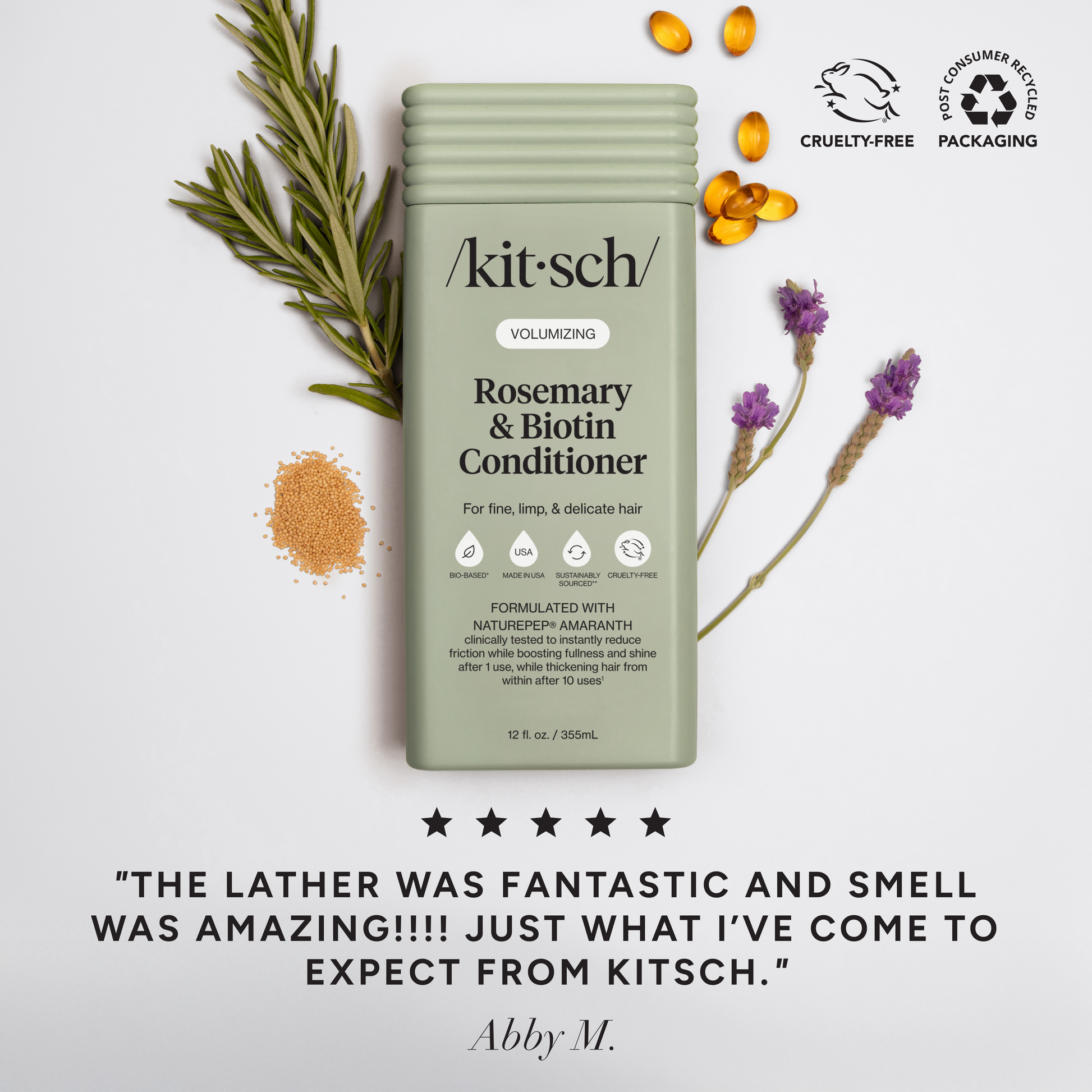 Marketing image for Kitsch Volumizing Rosemary & Biotin Conditioner (12 fl. oz.) styled with fresh rosemary, lavender, and biotin capsules. Similar to the shampoo ad, it features "Cruelty-Free" and "Post-Consumer Recycled Packaging" badges. A five-star testimonial from Abby M. reads, "The lather was fantastic and smell was amazing!!!! Just what I’ve come to expect from Kitsch".