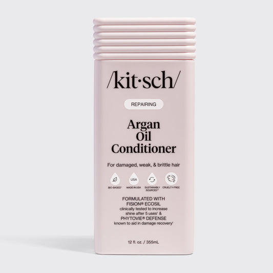 KITSCH Repairing Argan Oil Conditioner 12 fl. oz. — labeled REPAIRING, For damaged, weak, & brittle hair — icons: Bio-Based, Nontoxic, Sustainably Sourced, Cruelty-Free — Formulated with Fision® EcoSil clinically tested to increase shine after 5 uses & PhytoVie® Defense known to aid in damage recovery