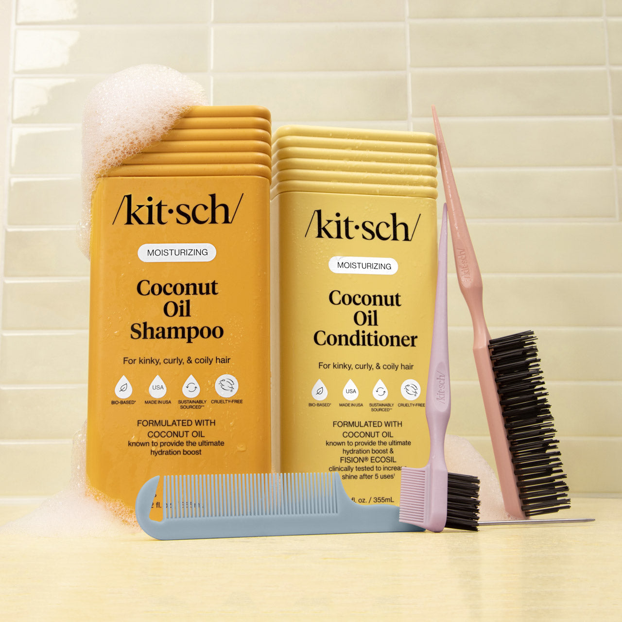 KITSCH Moisturizing Coconut Oil Shampoo & Conditioner Combo with detangling comb and styling brush on tiled background