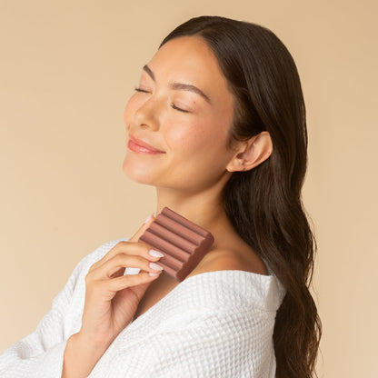 KITSCH Cleansing Amber Shores Body Wash Bar — model holding bar — Leaves skin wrapped with a woody aquatic scent — sustainable and travel-friendly—no plastic, no spills, just a compact bar that lasts