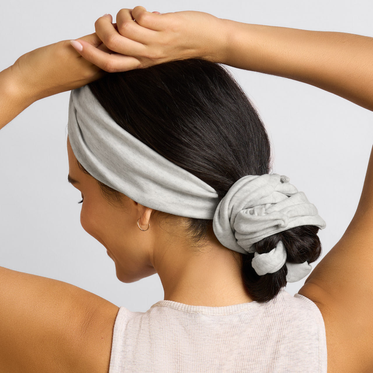 KITSCH Set & Flow Active Headband in Heather Gray — lifestyle model shot wearing set & flow headband — snag-free fabric is gentle on all hair types and textures