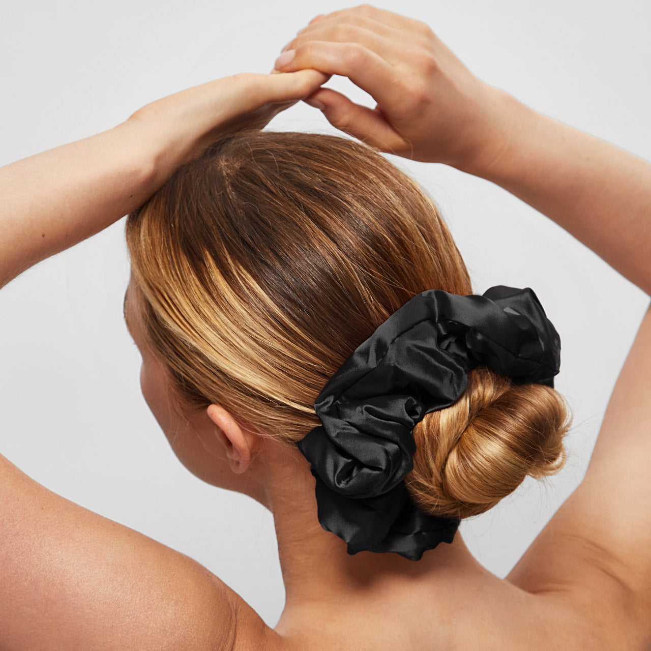 KITSCH Pillow Scrunchies® in Satin 4pc - Black — model lifestyle — black satin scrunchie styled in hair — soft enough to sleep in, cute enough to wear out