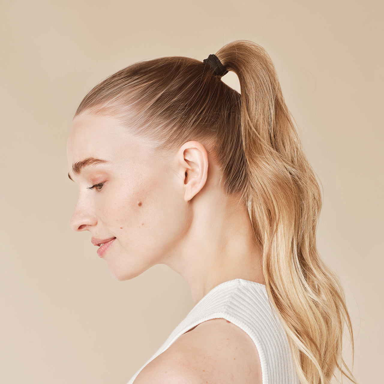 KITSCH Black Elastic Hair Ties 20pc Set — model styling ponytail with black elastic — Every ponytail's perfect hair basic & eco-friendly too — kind on your hair and the environment