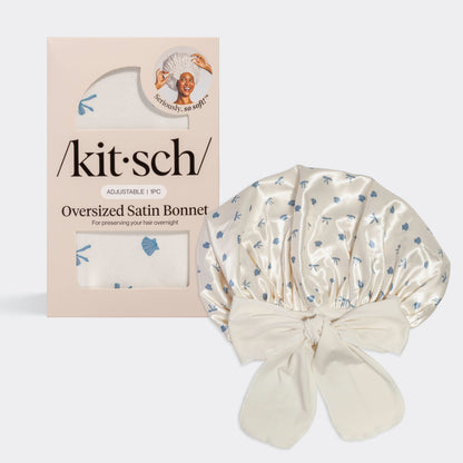 KITSCH Pearlized Cream & Coastal Blue Print Oversized Satin Bonnet — hero product shot with /kit·sch/ packaging — Adjustable, double-layered satin with coastal-inspired dainty bows & seashells print — For preserving your hair overnight