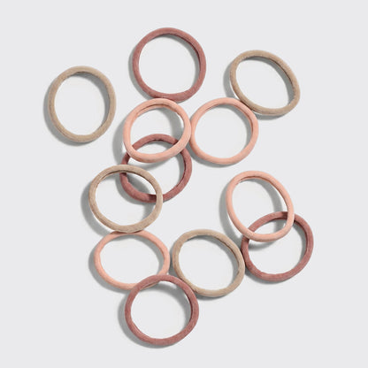 Rosewood Seamless Hair Elastics 12pc Set - 12 seamless recycled nylon hair elastics in light beige, blush pink, and rosewood scattered on grey background
