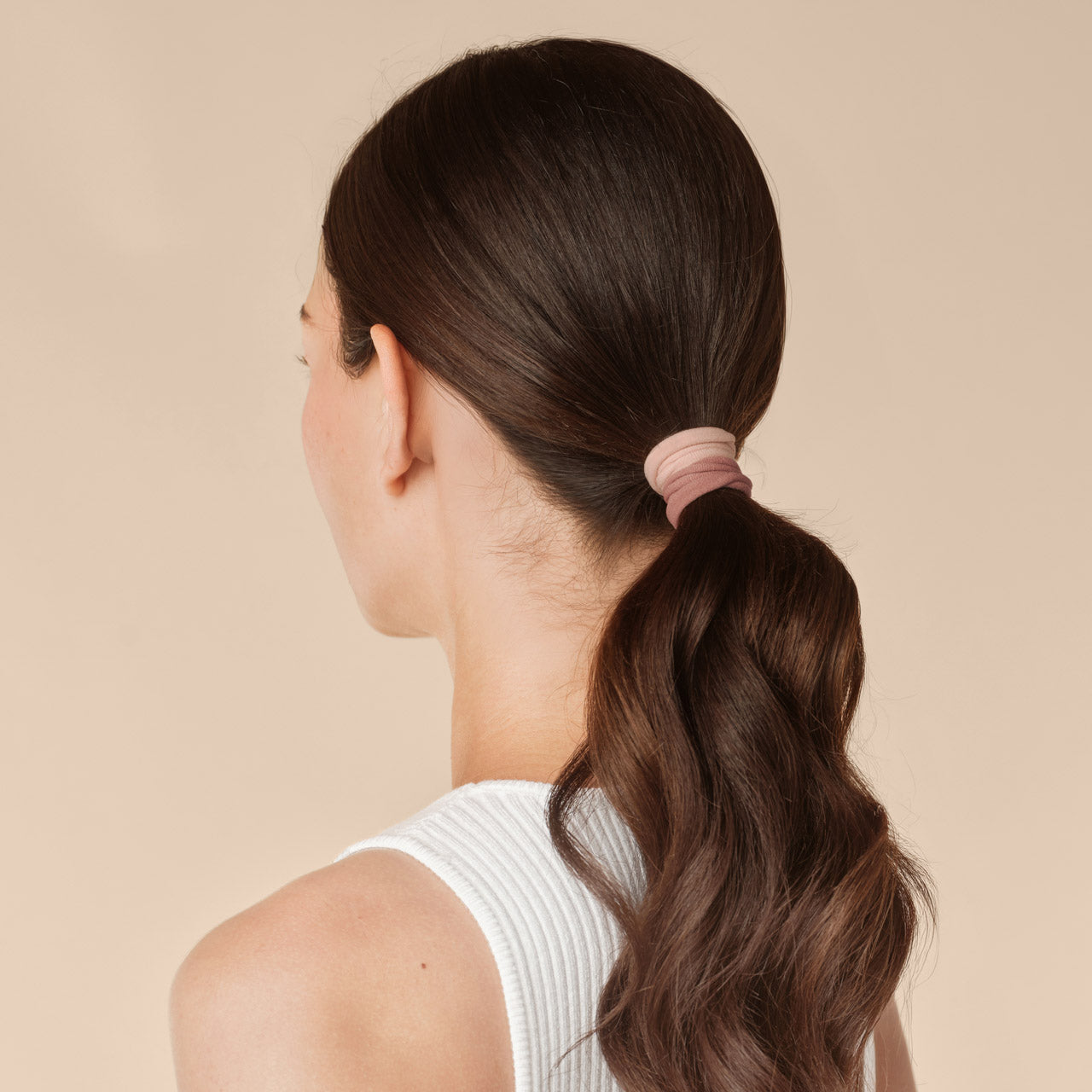 Rosewood Seamless Hair Elastics 12pc Set - model from behind with low ponytail secured with rosewood seamless hair ties
