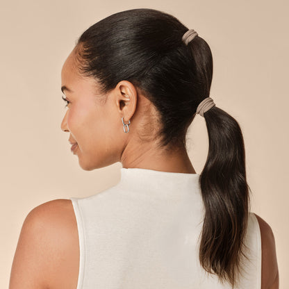 Rosewood Seamless Hair Elastics 12pc Set - model side profile with double ponytail secured with rosewood seamless hair ties