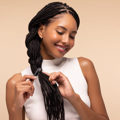 KITSCH No-Snag Elastics 200pcs & Recycled Plastic Elastic Cutter Set — model using the clear no-snag elastics to tie back hair — no-crease, no-snag hold for all hair types — everyday styling essential