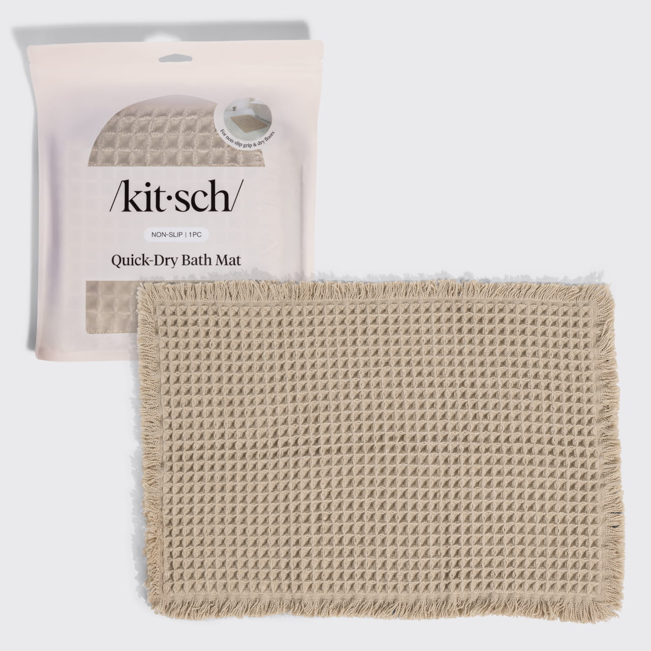 Kitsch Quick-Dry Bath Mat in camel hero image, shown with its retail packaging (non-slip, 1 piece) behind the folded mat.