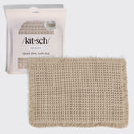 Kitsch Quick-Dry Bath Mat in camel hero image, shown with its retail packaging (non-slip, 1 piece) behind the folded mat.
