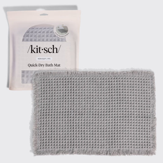 Kitsch Quick-Dry Bath Mat in gray hero image, shown with its retail packaging (non-slip, 1 piece) behind the folded mat.