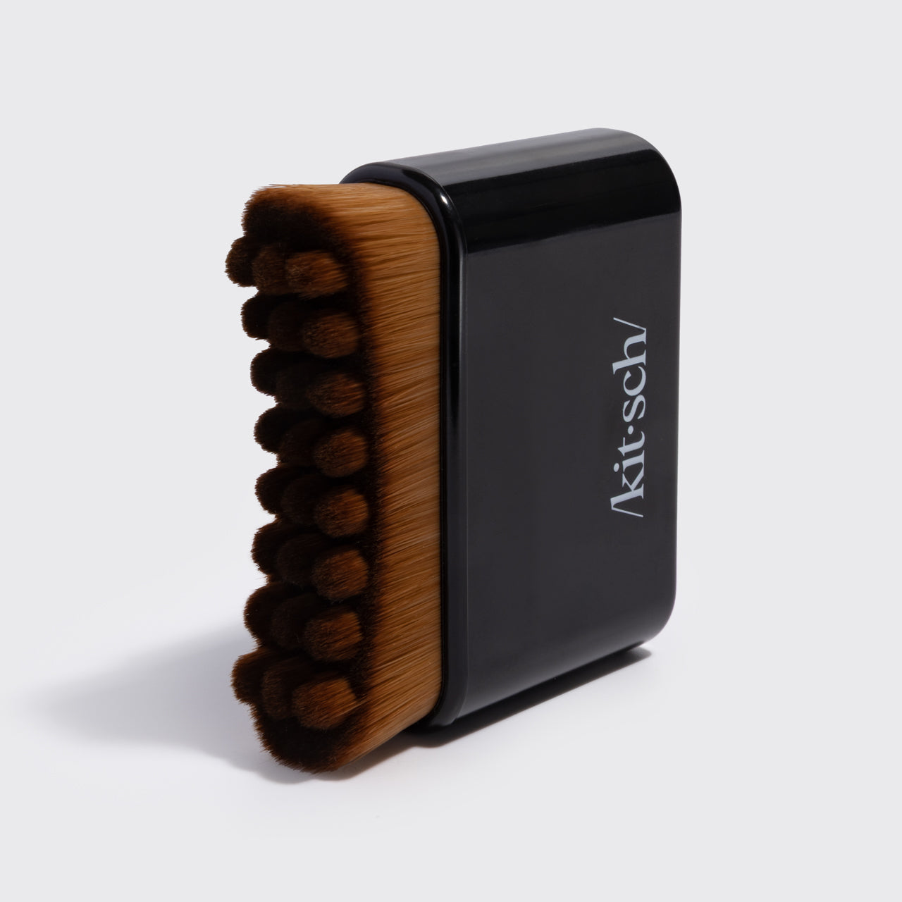 Close-up of the black Kitsch Lymphatic Contour Face Brush showing its soft hypoallergenic bristles