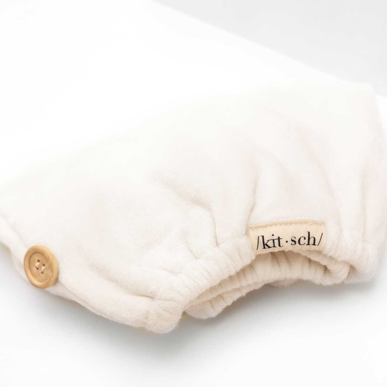 Close-up view of the soft white organic bamboo hair towel fabric highlighting its plush texture.