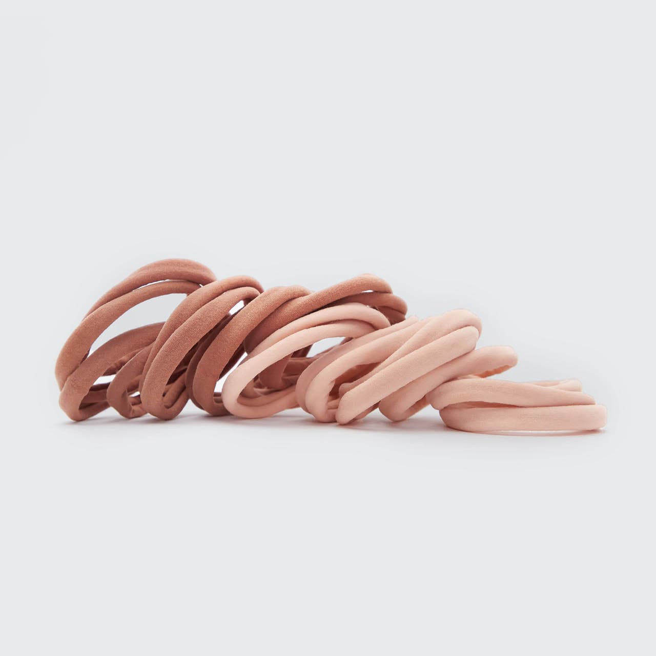 KITSCH Blush Elastic Hair Ties 20pc Set — product lifestyle shot showing pack of 20 in blush tones — consciously created from recycled materials — glide gently through hair for a tight all-day hold