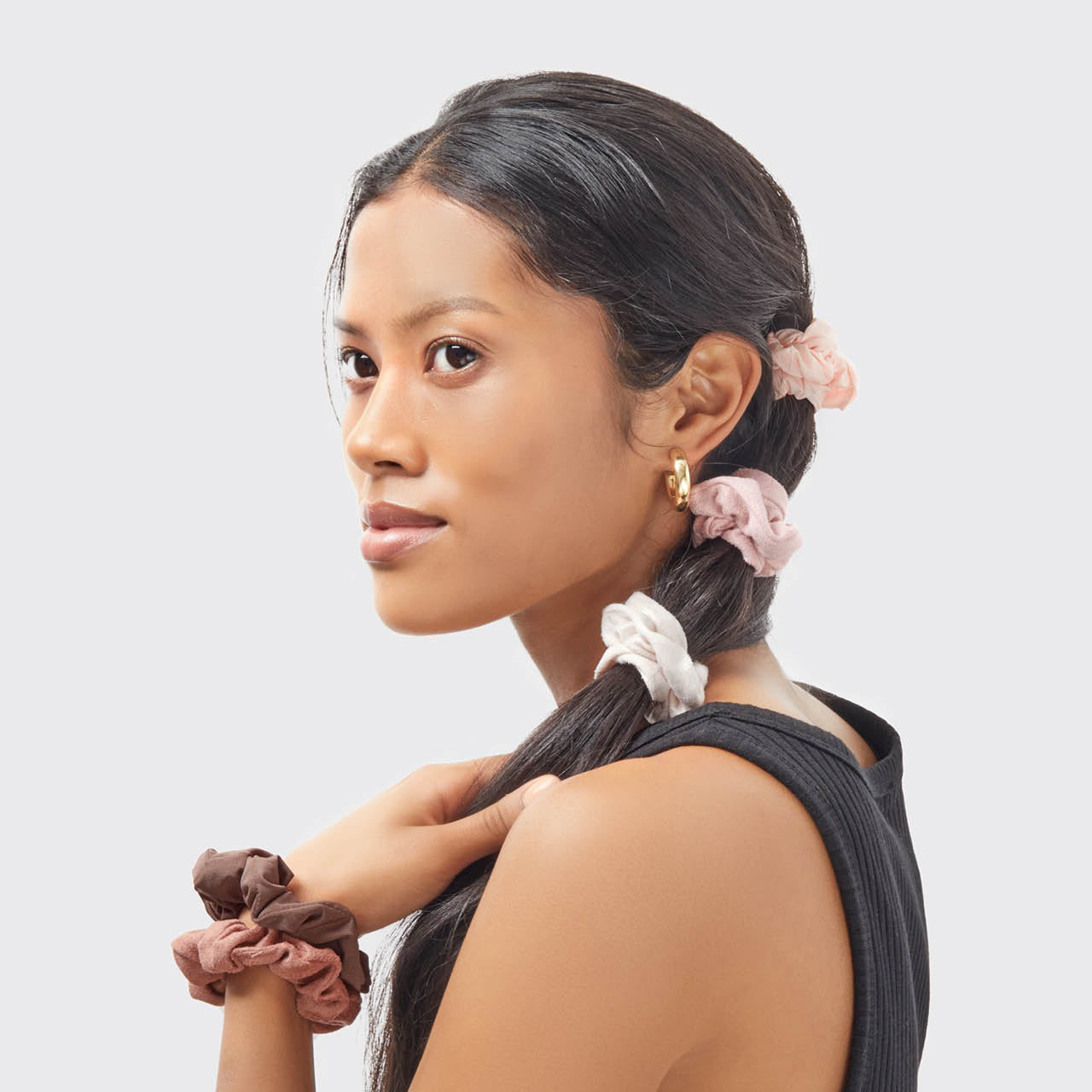 KITSCH Assorted Textured Scrunchies 5pc Set in Terracotta — model styling hair with terracotta textured scrunchies — 5pc set in warm earth tones, gentle on strands