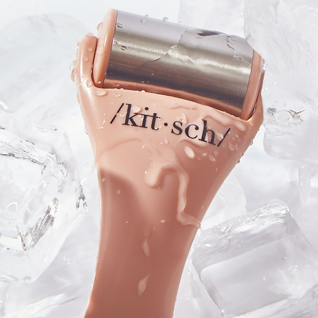 Terracotta Ice Roller shown with skincare products in morning routine flat lay