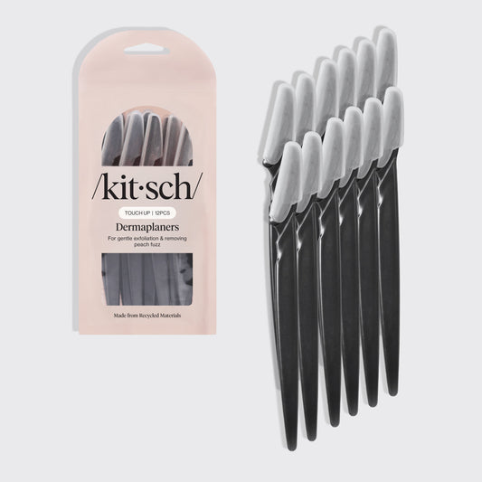 Kitsch Touch Up Dermaplaners (12 pcs) in Black with protective blade covers, displayed beside the recyclable blush-pink retail packaging. Designed for gentle facial exfoliation and peach fuzz removal.
