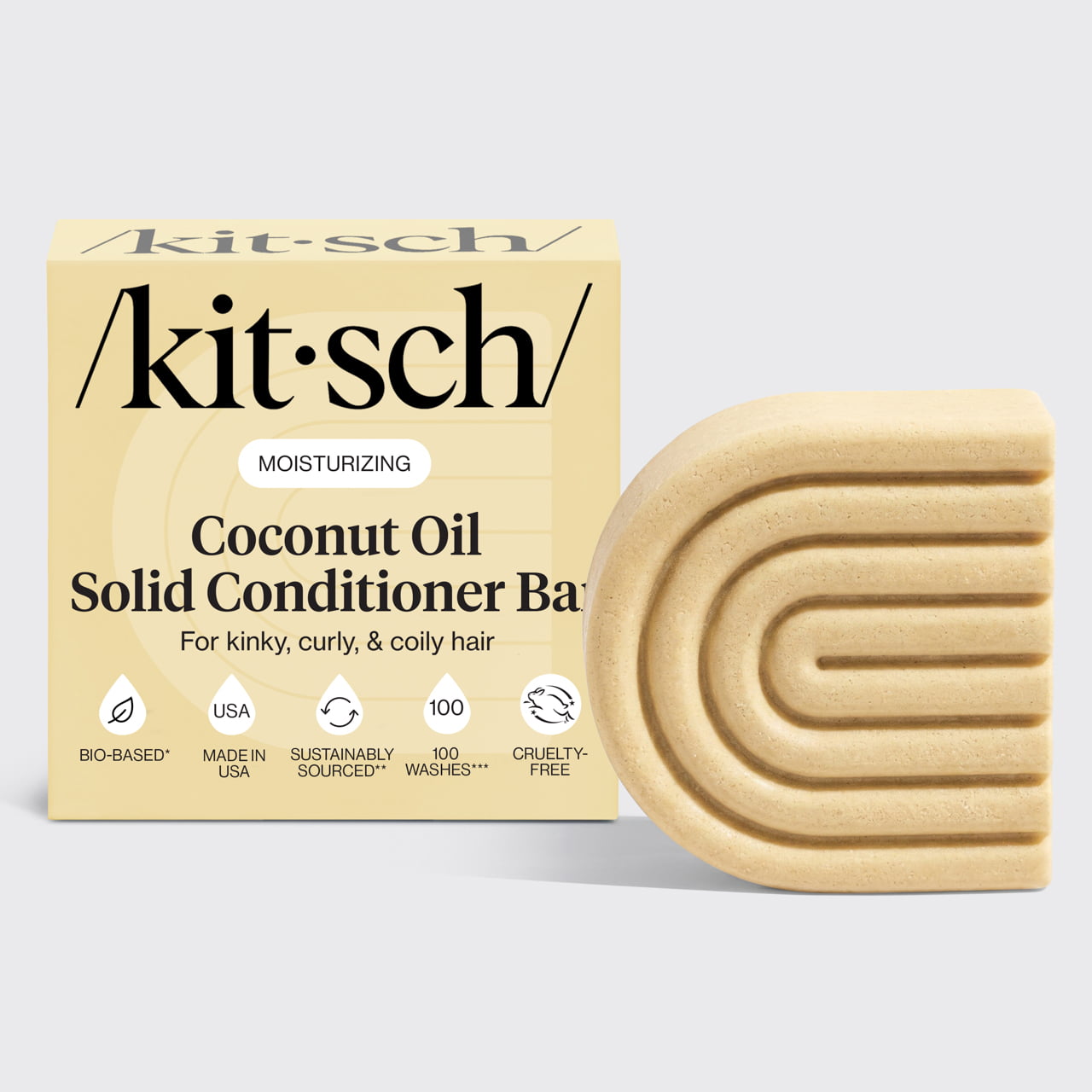 Kitsch Coconut Oil Solid Conditioner Bar with packaging displayed beside the bottle-free conditioner bar for moisturizing kinky, curly, and coily hair.