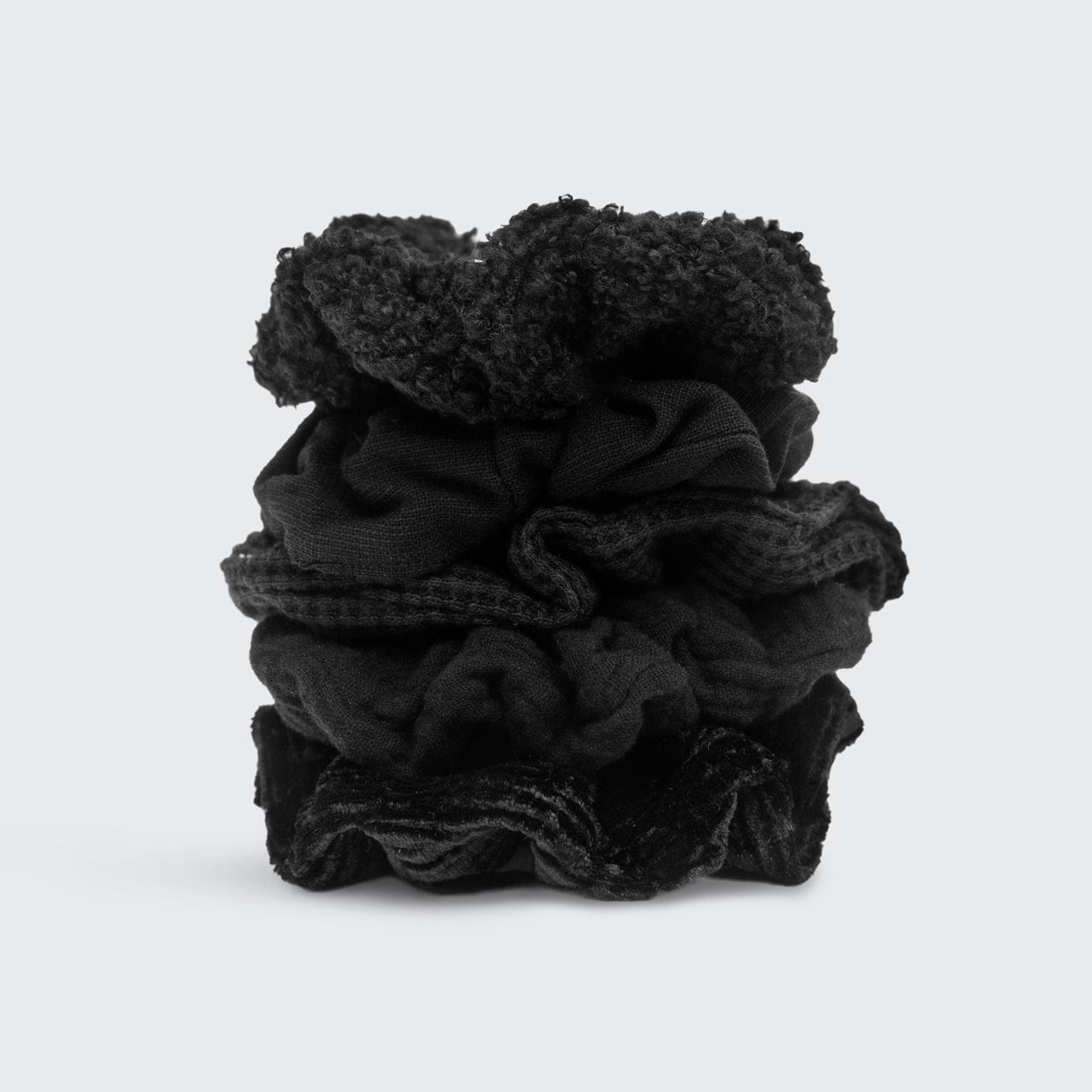 KITSCH Assorted Textured Scrunchies in Black — product flat lay showing assorted black scrunchie textures — satin, crepe, and velvet mix in solid black tones